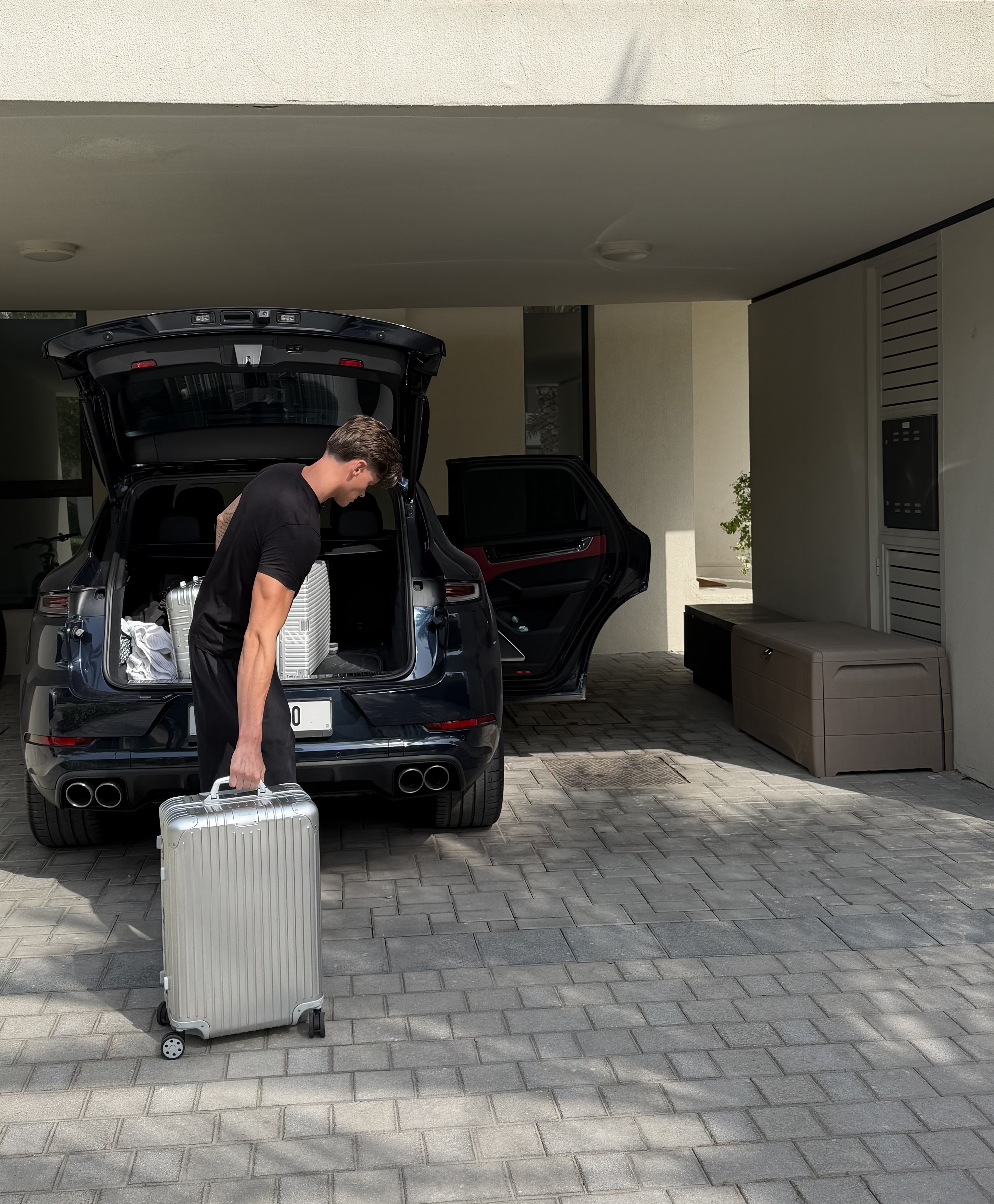 Freddie Sadler unloading a suitcase from a car